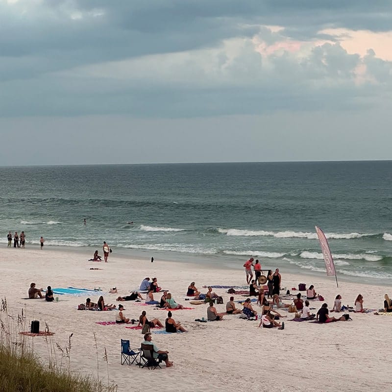 Beachgoers sitting on Navarre Beach