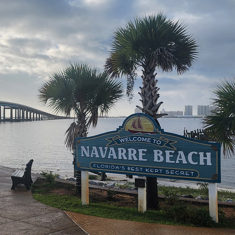 navarre beach sign next to sound-min
